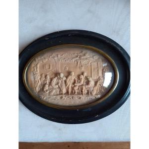 Placca ovale in cera  scolpita con scena conviviale Inghilterra, XIX secolo