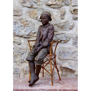 Goldscheider Child Sitting On An Armchair
