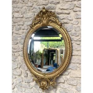 Antique Oval Mirror With Pediments And Beaded Gilt With Gold Leaf, Beveled Glass.