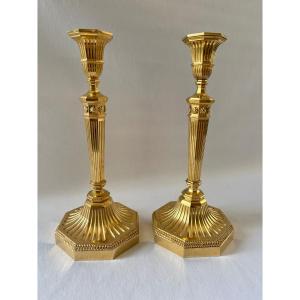 Pair Of Directoire Style Candlesticks In Gilt Bronze