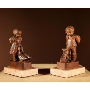 Black Forest Original Pair Of Fine Carved Sculptures Of A Boy And Girl.
