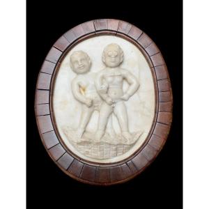 A Fun Early 19th Century Carved White Marble Plaque Of Two Mischievous Boys