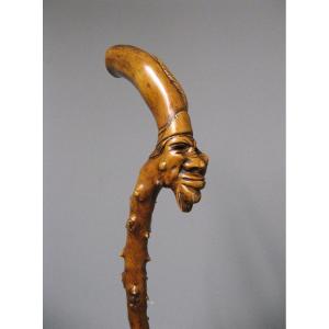 Monoxyl Cane In Boxwood Carved With Grotesque Head Of Voodoo Sorcerer. 19th Century Popular Art.