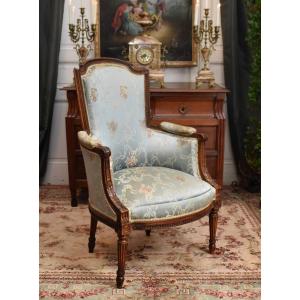 Louis XVI Period Bergère Chair, 18th Century, Decorated With Heart Motifs, Coins, And Fluted Spindle Legs.