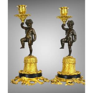 Pair Of Bronze Candelabras With Brown And Golden Patina With Cherb Decor From The 19th C.