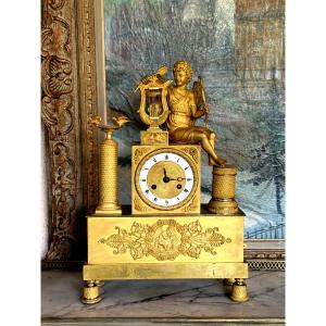 Empire Period Gilt Bronze Clock Decorated With Eros Playing The Harp