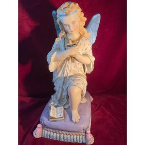 Praying Angel Kneels With A Cross