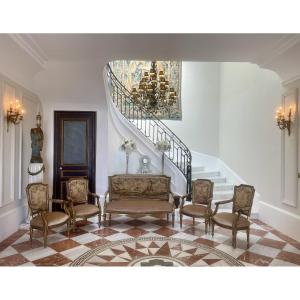 Living Room With A Sofa And Four Chairs 