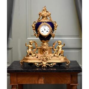 Louis XVI Style Sèvres Porcelain And Gilt Bronze Clock, Decorated With Rams And Putti