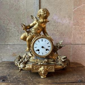 A Cherub Clock, In Gilded Spelter, Dating From The 19th Century.