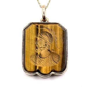 0320. Gold Pendant Decorated With A Carved Tiger's Eye