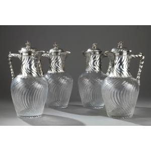 A Set Of Four Ewers In Silver And Twisted Crystal