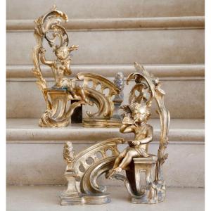 Pair Of Andirons With Putti In Gilt Bronze
