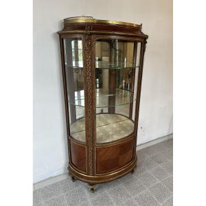 A Curved Louis XVI Style Display Cabinet By Jansen, Crafted From Marquetry Wood And Gilt Bronze.