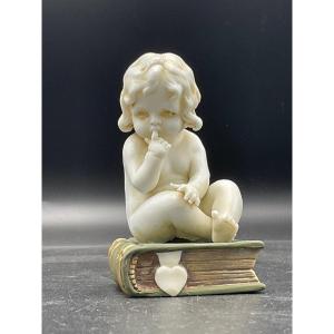 Biscuit From The Müller Factory Representing A Little Girl Sitting On A Book.