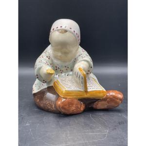 Berthe Savigny Colored Earthenware Baby Sitting With A Book And A Biscuit Hb Quimper Factory.