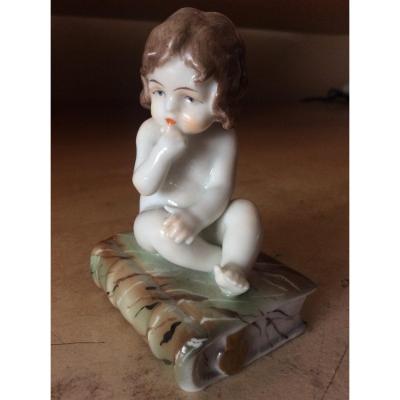 Polychrome Porcelain By Müller Representing A Little Girl Sitting On A Book.