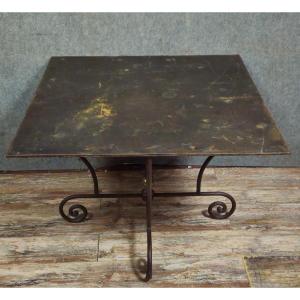 Wrought Iron Table With Sculptural Base, Adorned With Scrolls And A Central Brass Element. 