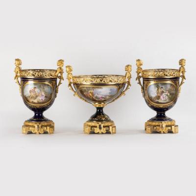 Dans le go&ucirc;t de la Manufacture de S&egrave;vres, garniture de trois coupes en porcelaine et monture en bronze dor&eacute;, XIXe
