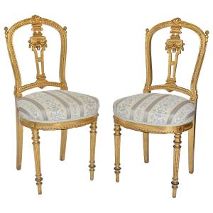 Pair Of Louis XVI Style Chairs In Gilded Wood