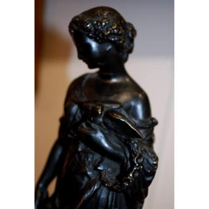 Young Woman Holding A Bird In Her Arms Bronze With Brown Patina