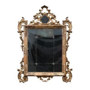 Grande specchiera in legno intagliato e dorato. Venezia, XVIII-XIX secolo.