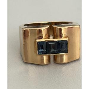 1242- Yellow Gold Bridge Ring With Calibrated Blue Stones