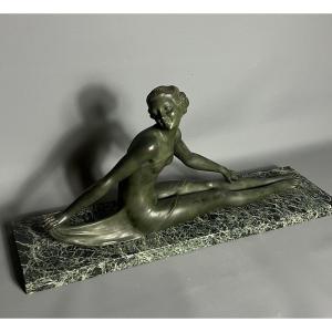 Elegant Bronze Sculpture Representing A Seated Nude Woman, In A Graceful And C
